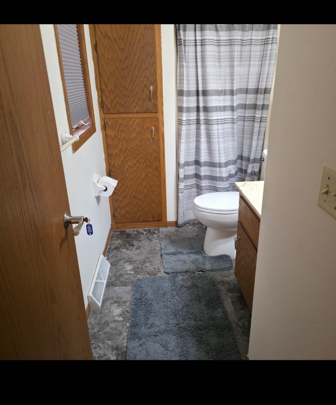 Bathroom with toilet and shower at Floxy AbilityNest