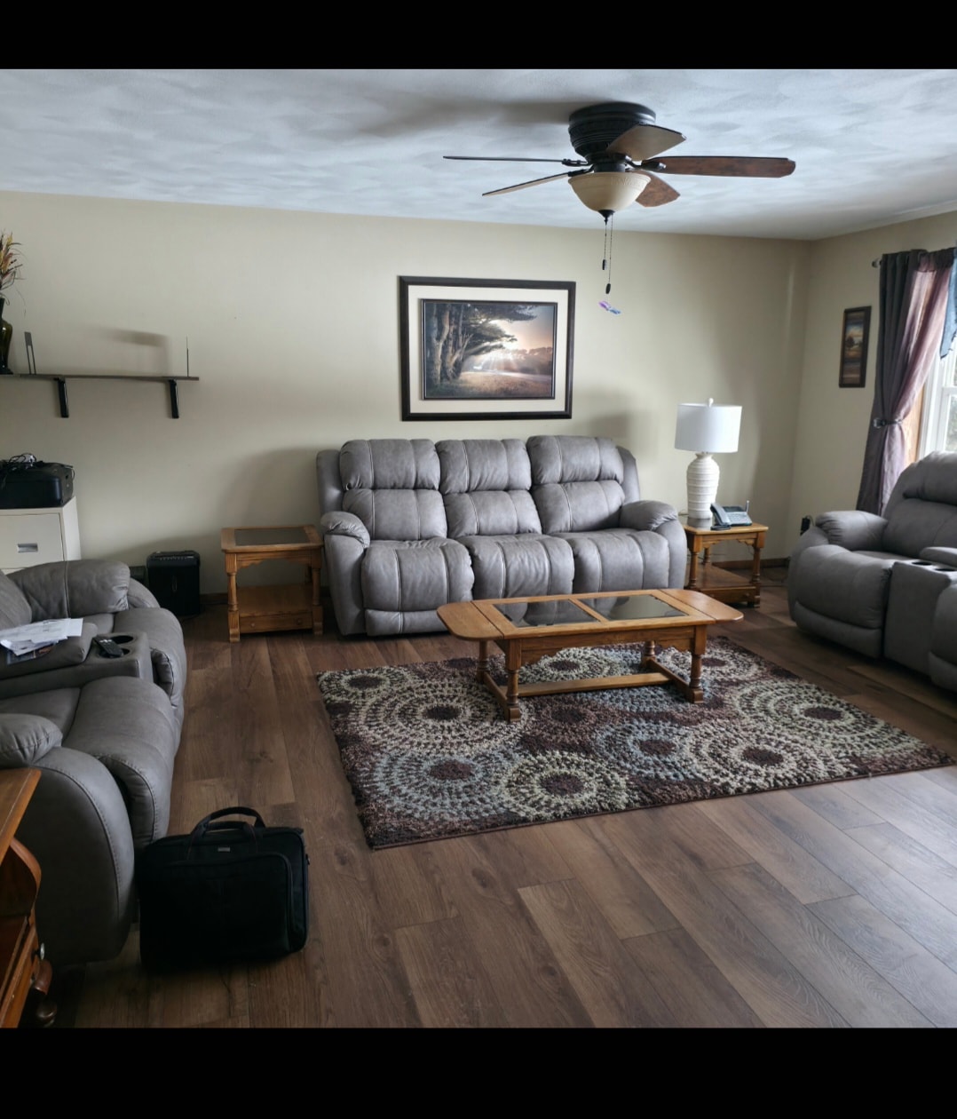 Spacious living room with gray recliners at Floxy AbilityNest