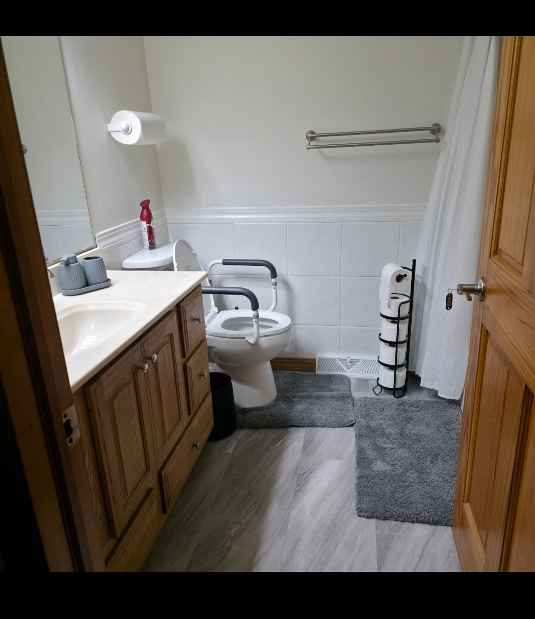 Modern bathroom with toilet seat riser at Floxy AbilityNest